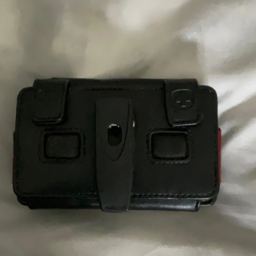 Swiss mobility case. Fits onto belt, and has a loop for a lanyard or strap.
